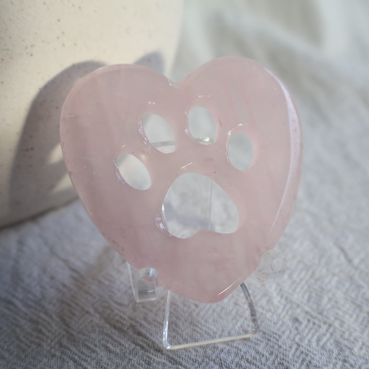 Crystal heart carvings with paw print cut-outs, available in Rose Quartz, Fluorite and Dream Amethyst.