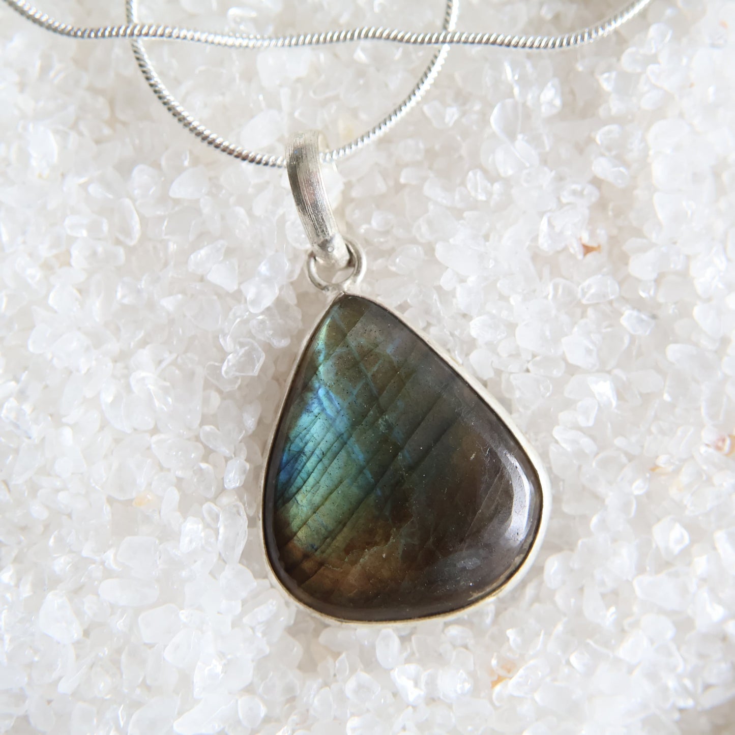 Labradorite crystal pendant with blue and gold flash and wrapped s925 silver border, exact piece shown