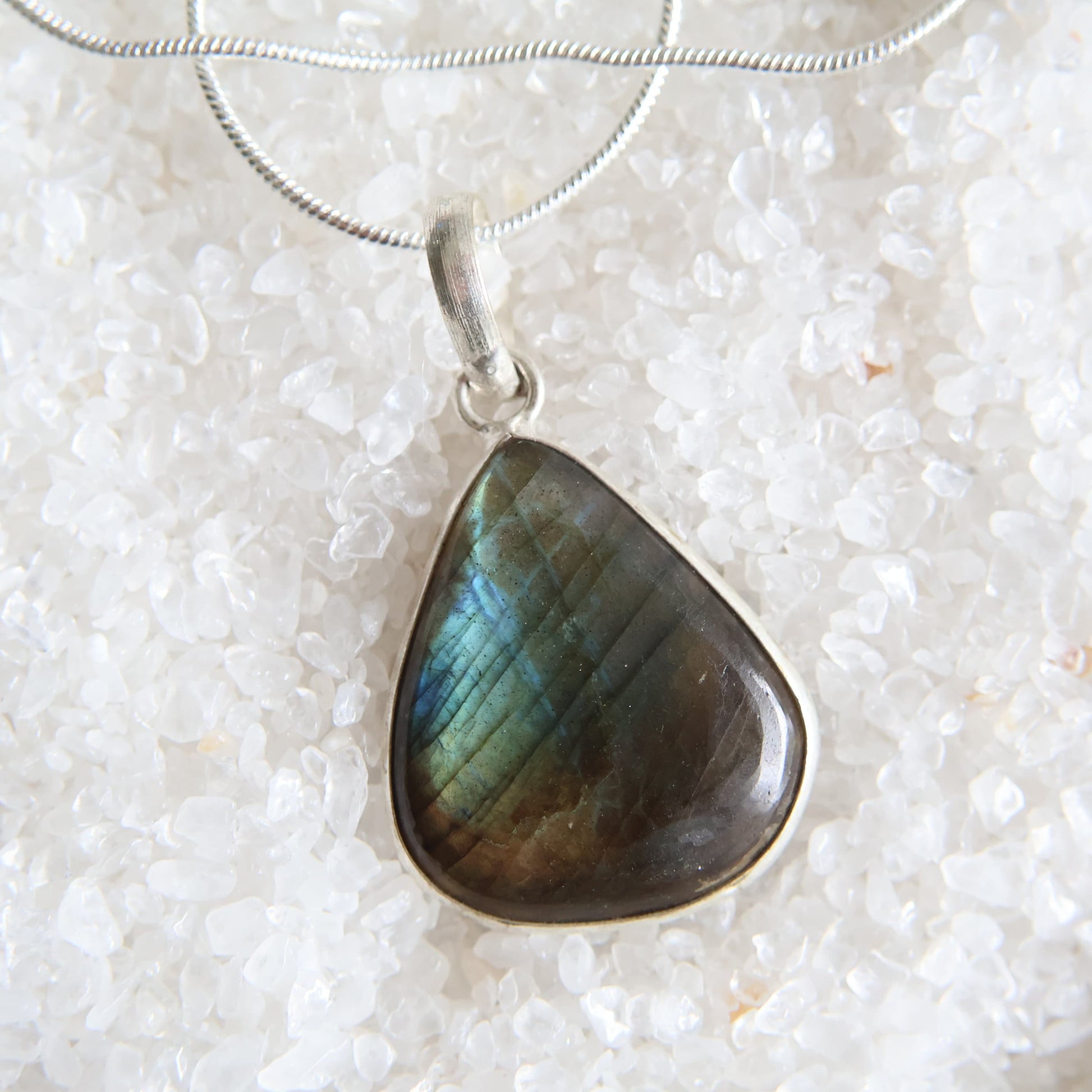 Labradorite crystal pendant with blue and gold flash and wrapped s925 silver border, exact piece shown