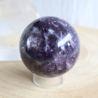 Lepidolite crystal sphere measuring 5.5cm and weighing 262g, with natural mineral inclusions and polished finish.