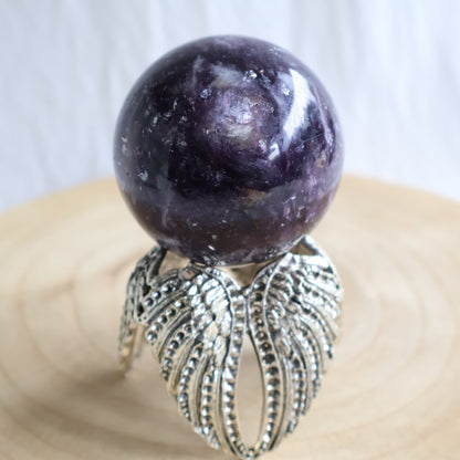 Lepidolite crystal sphere measuring 5.5cm and weighing 262g, with natural mineral inclusions and polished finish.