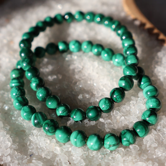 Malachite 6mm bead stretch bracelet with rich green beads and distinctive natural banding and swirling patterns.