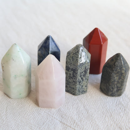 Collection of mini crystal generators available in Phoenix Stone, Rose Quartz, Pyrite, Moss Agate, and Sodalite with polished pointed tops and natural colour variations.