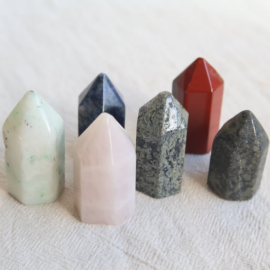 Collection of mini crystal generators available in Phoenix Stone, Rose Quartz, Pyrite, Moss Agate, and Sodalite with polished pointed tops and natural colour variations.