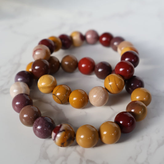 Mookaite 10mm bead stretch bracelet with natural red, mustard yellow, cream, burgundy and earthy brown tones.