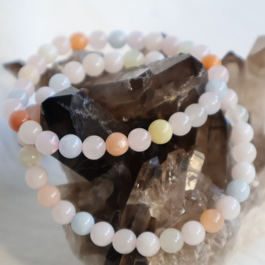 Morganite 6mm bead stretch bracelet with soft blush pink, peach and natural pastel tones.