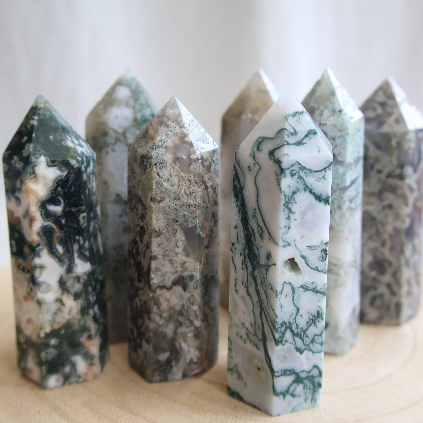 white and green dendritic moss agate generator polished point