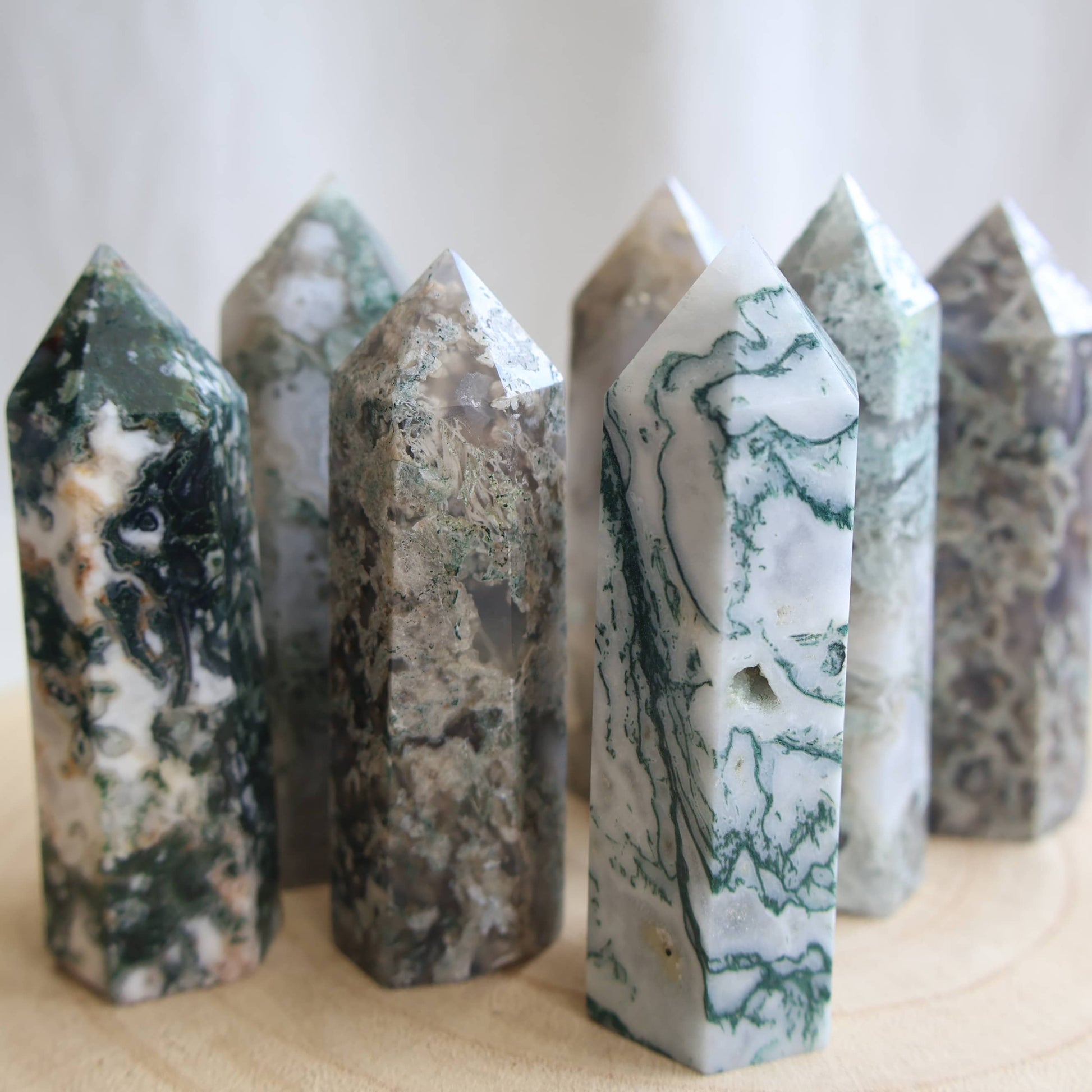 white and green dendritic moss agate generator polished point