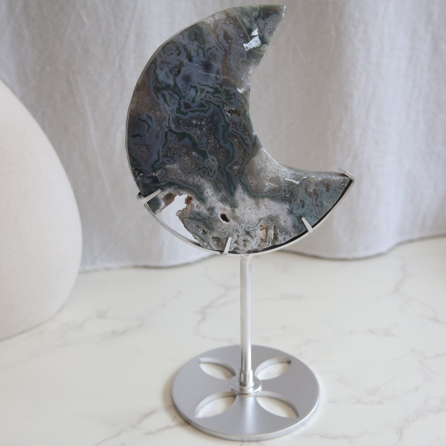 Moss Agate moon carving on silver stand with green inclusions and natural patterns