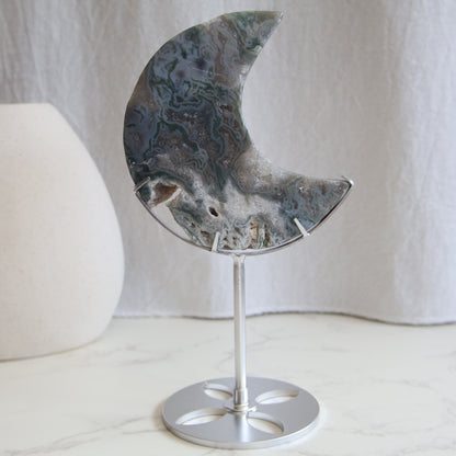 Moss Agate moon carving on silver stand with green inclusions and natural patterns