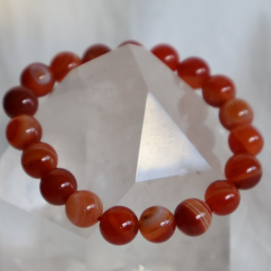 Orange Sardonyx 10mm bead stretch bracelet with warm orange, cream and white tones and natural banded patterns.