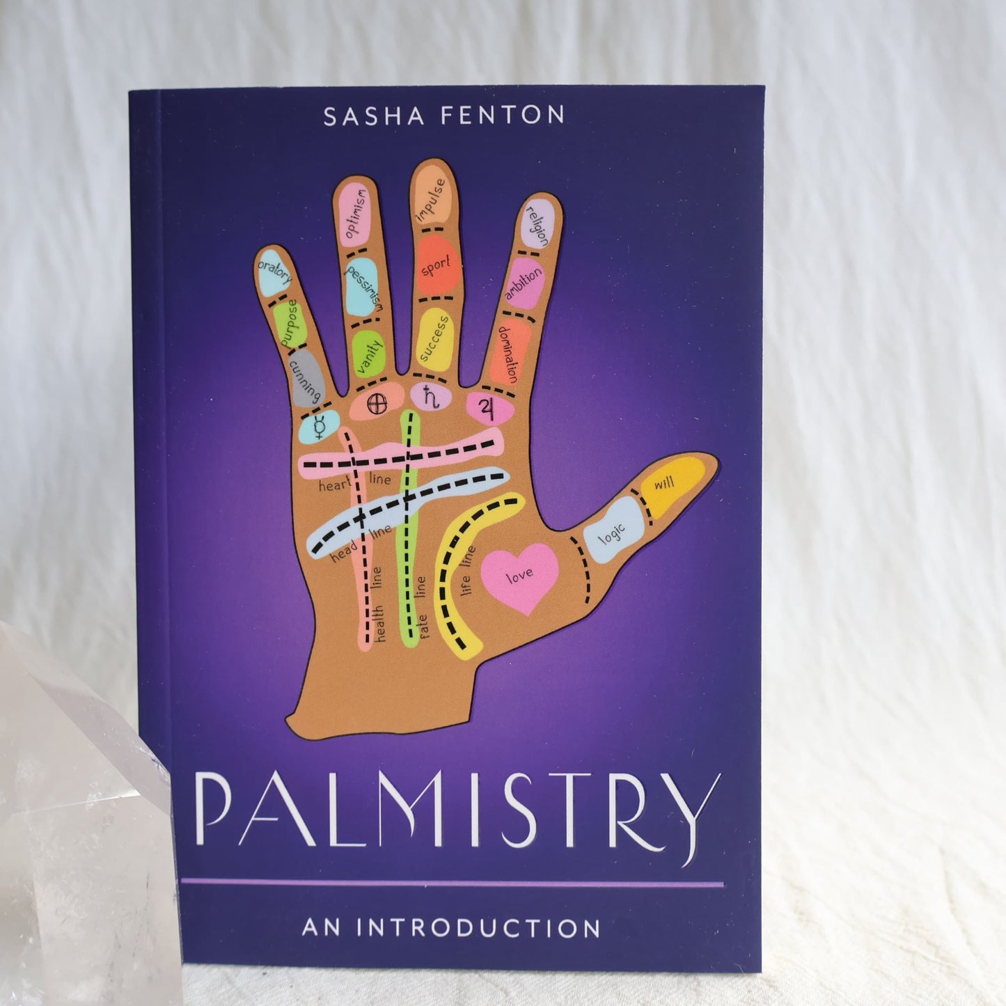 Palmistry: An Introduction paperback book by Sasha Fenton featuring an illustrated palm reading guide on the cover.