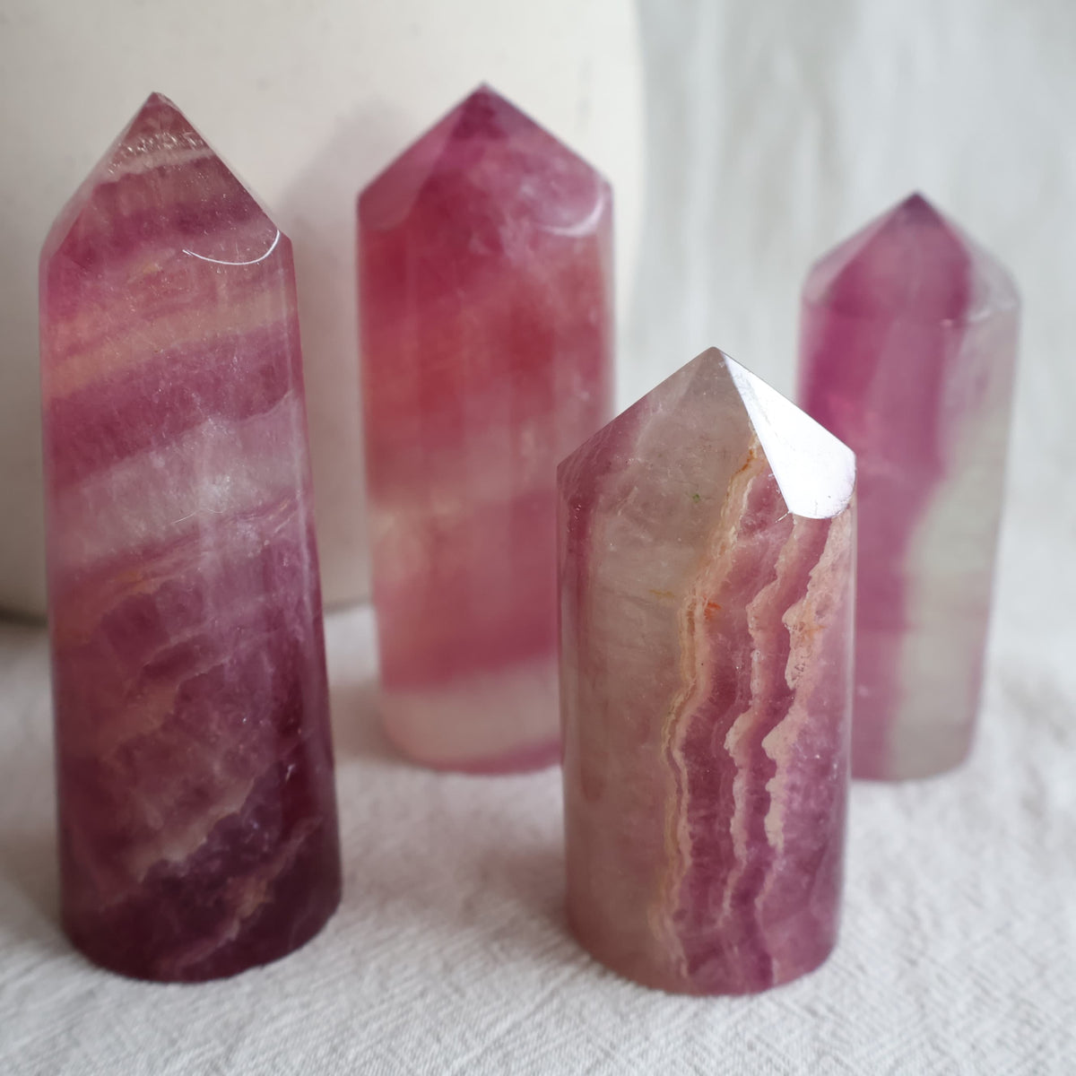 Pink Fluorite polished crystal points in varying shades of pink and purple with natural banding, available to choose by exact piece.