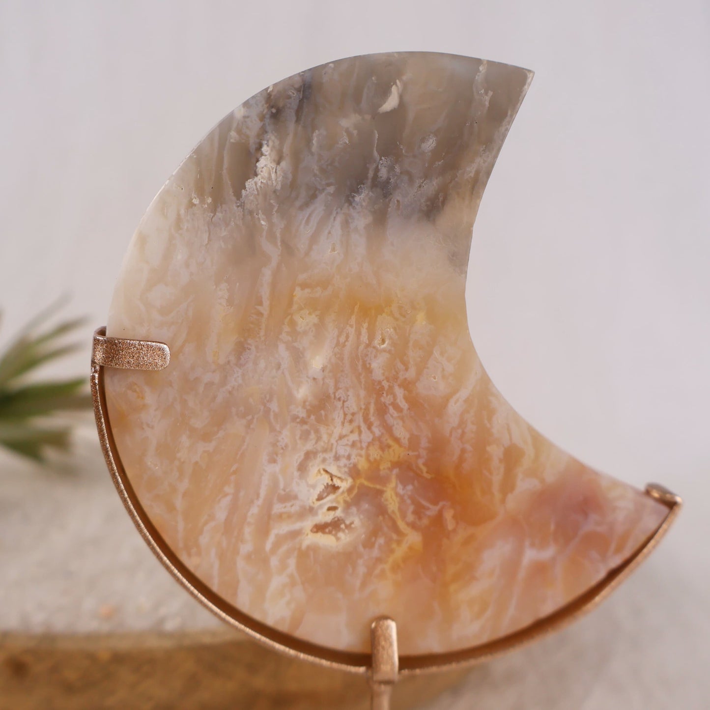 pink plume agate moon on gold stand natural crystal