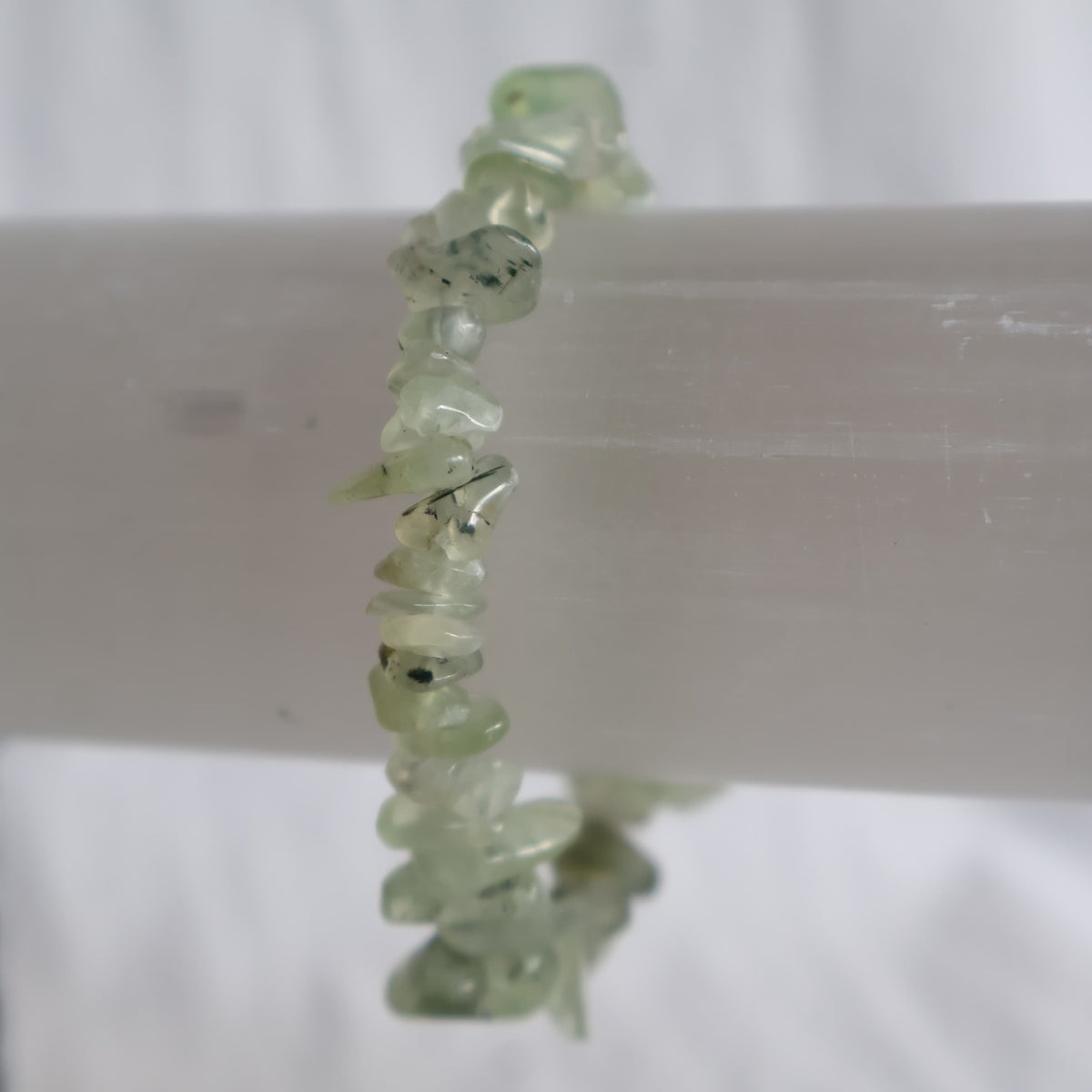 Prehnite chip stretch bracelet with natural soft green crystal chips and subtle variations in colour and translucency.