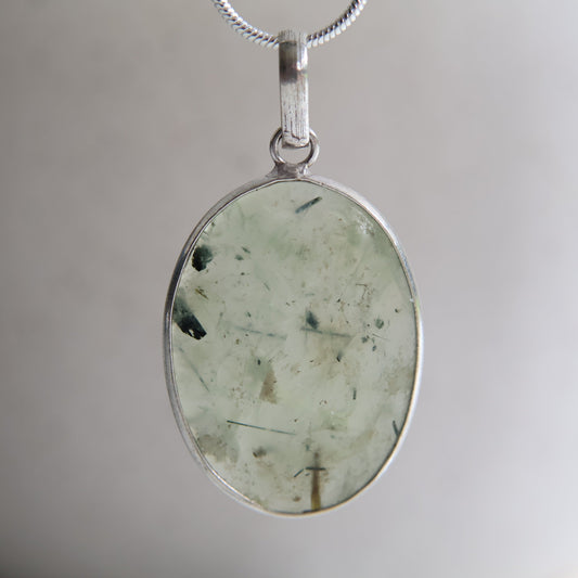 Prehnite crystal pendant with soft translucent green tones and wrapped s925 silver border, exact piece shown