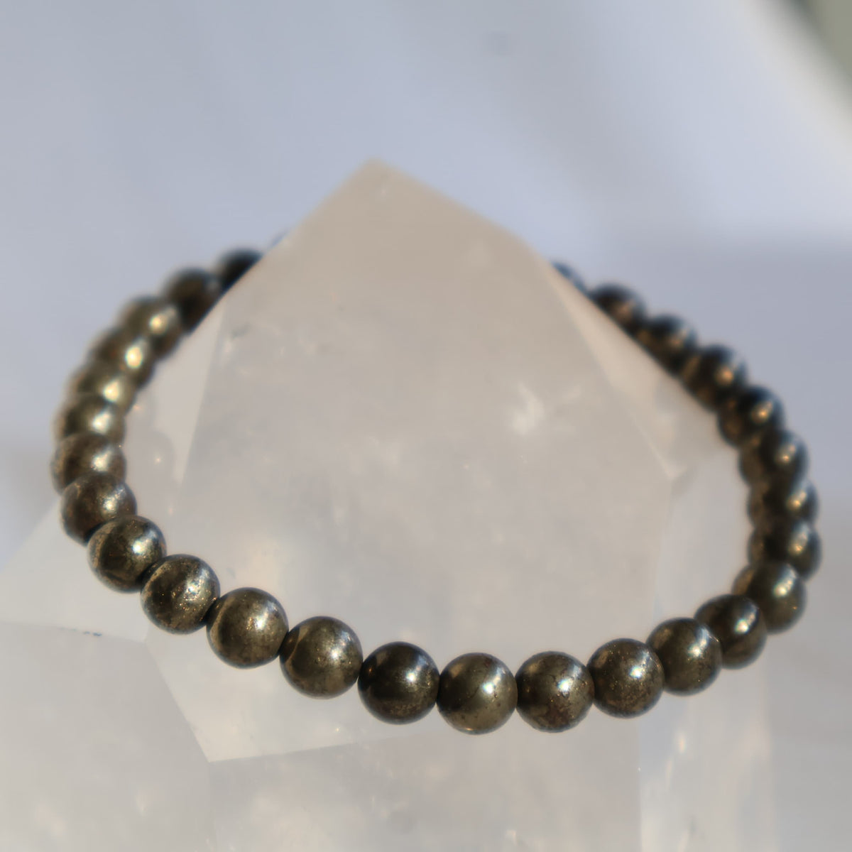 Pyrite 6mm bead stretch bracelet with metallic gold-toned beads and a natural reflective lustre.