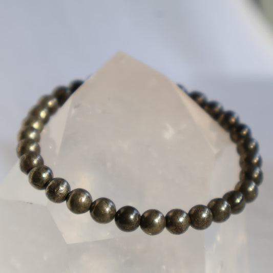 Pyrite 6mm bead stretch bracelet with metallic gold-toned beads and a natural reflective lustre.