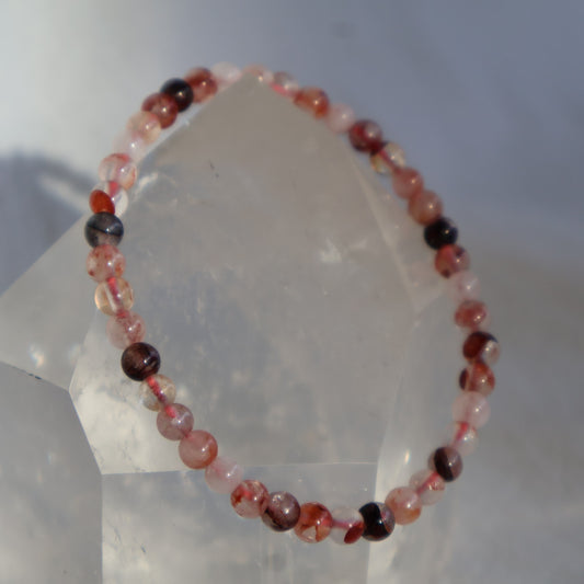 Fire Quartz 4mm bead stretch bracelet with clear to milky Quartz and natural red, rust and orange iron oxide inclusions.