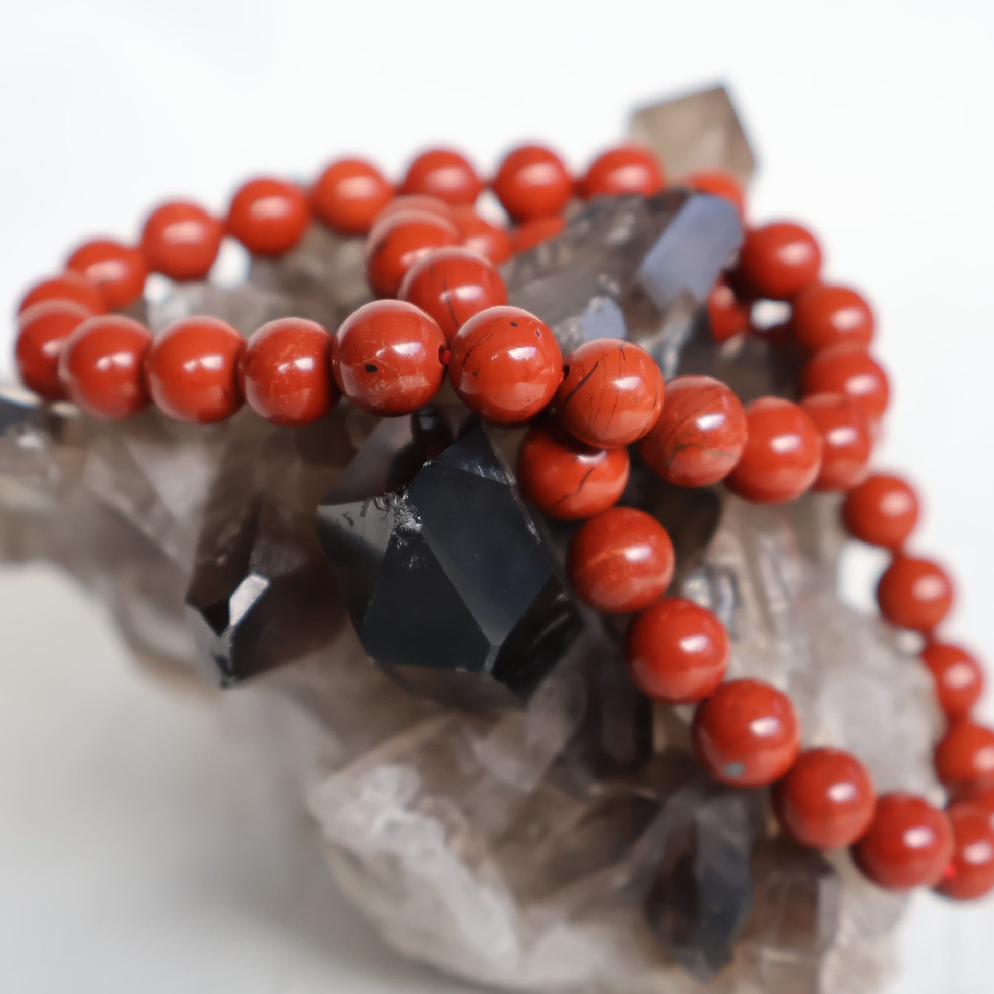 Red Jasper 8mm bead stretch bracelet with smooth, rich earthy red beads and subtle natural colour variations.