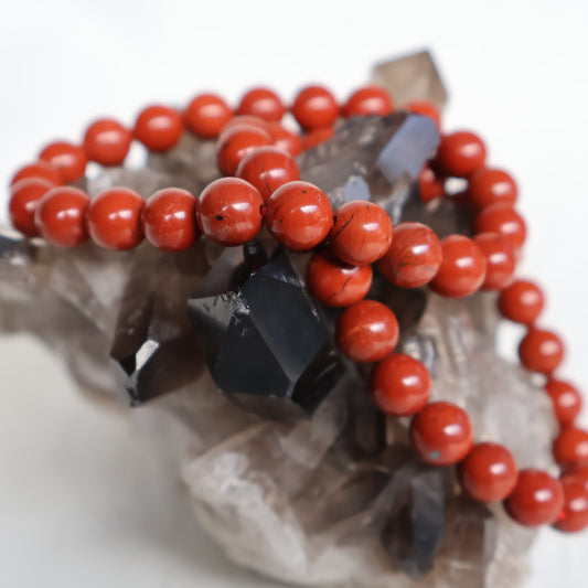 Red Jasper 8mm bead stretch bracelet with smooth, rich earthy red beads and subtle natural colour variations.