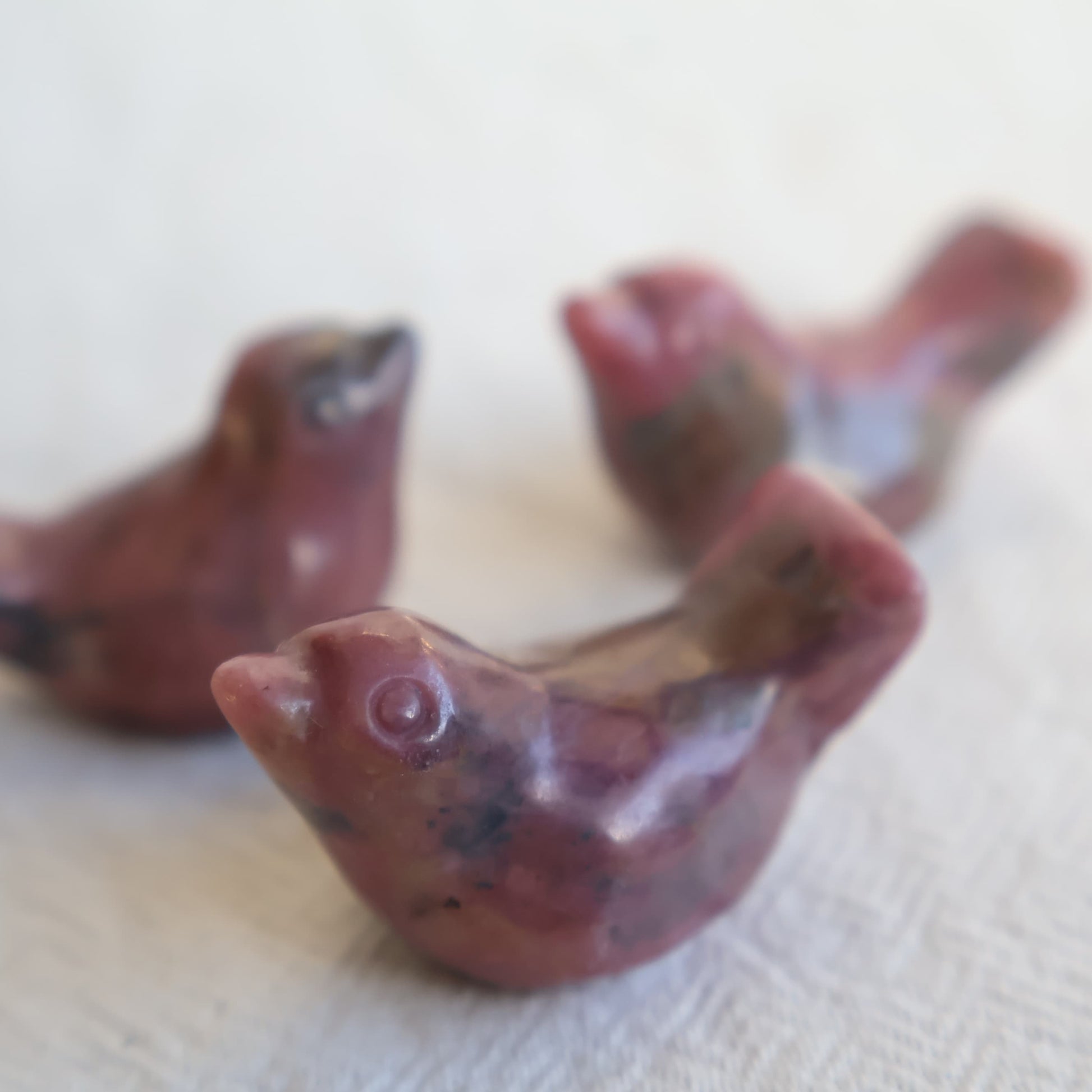 Mini Rhodonite bird carving with natural pink and black veining