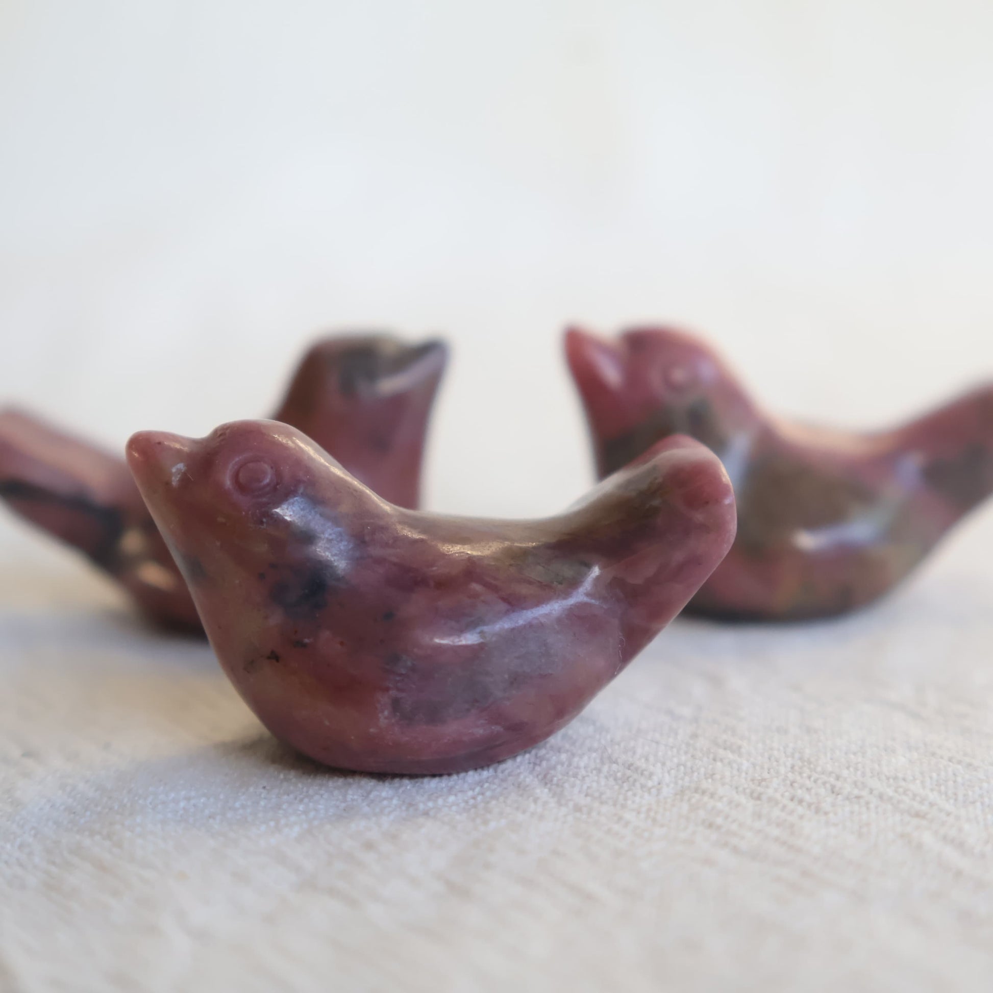 Mini Rhodonite bird carving with natural pink and black veining