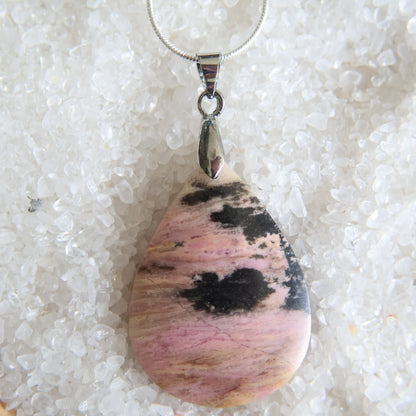 Rhodonite crystal pendant with soft pink tones and natural dark veining, exact piece shown