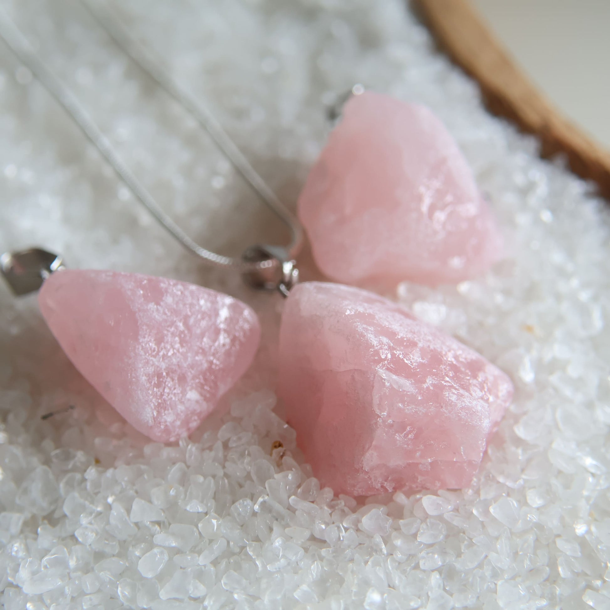 Raw rose quartz crystal pendant with natural pink tones, intuitively chosen