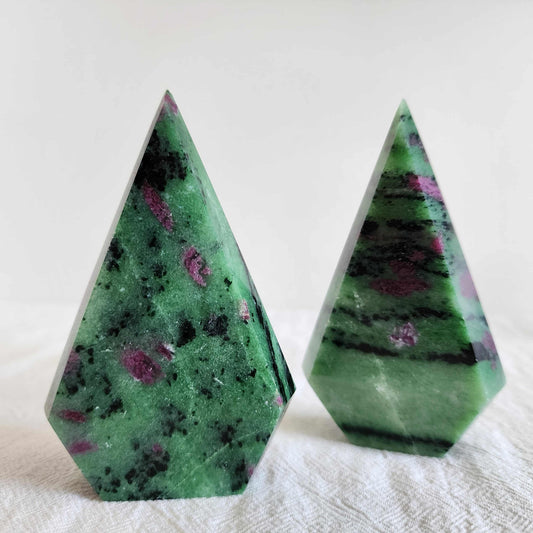 ruby in zoisite faceted freeform point polished green stone with ruby inclusions standing upright