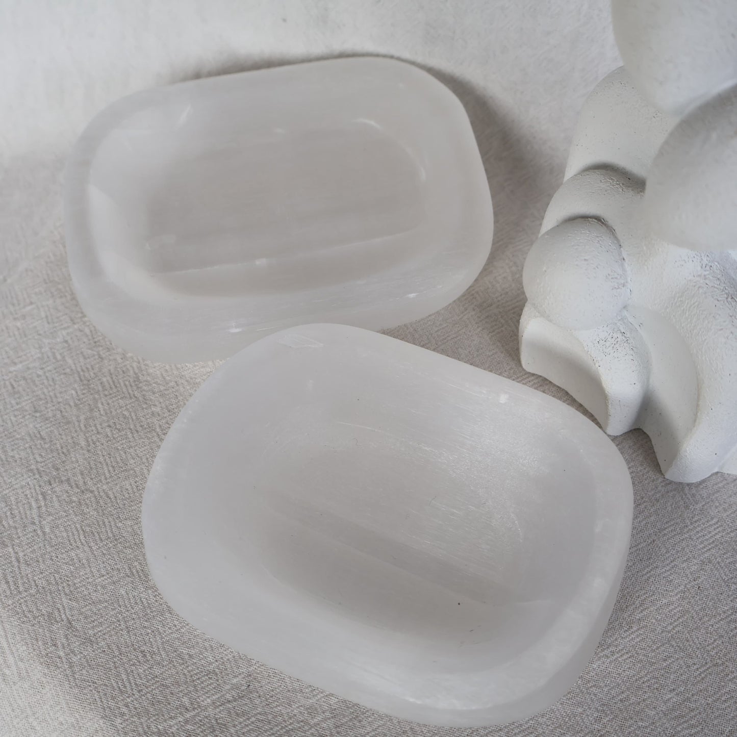 Satin Spar crystal dish with luminous white colouring and a natural silky sheen, approximately 10cm wide.