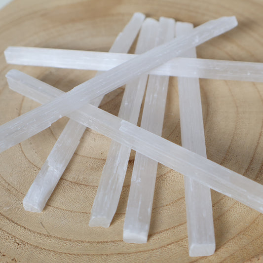 Large Satin Spar crystal rod approximately 15cm long with luminous white colouring and natural silky fibrous striations.