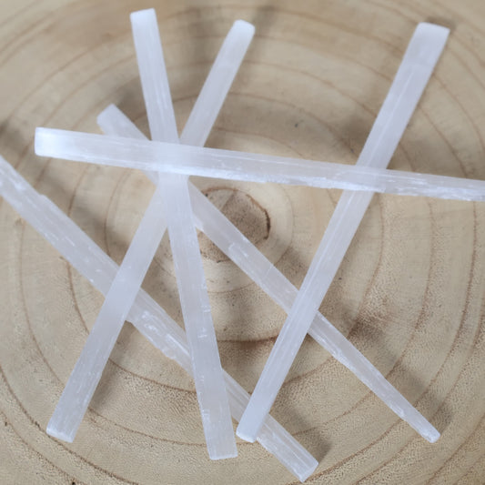 Small Satin Spar crystal rod approximately 15cm long with luminous white colouring and natural silky fibrous striations.