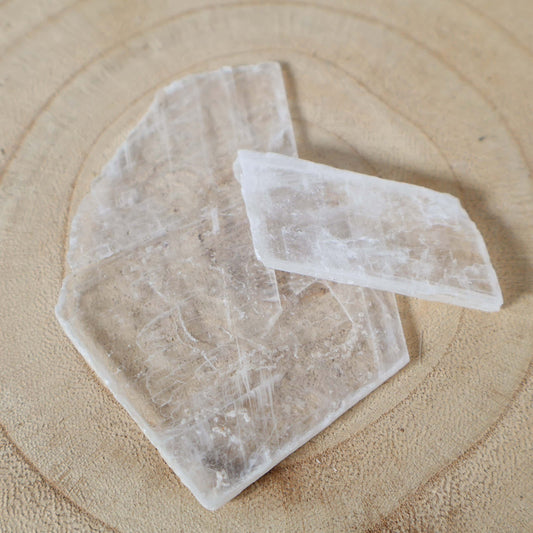 Small genuine Selenite crystal slab with a naturally transparent to translucent appearance and visible layered structure.