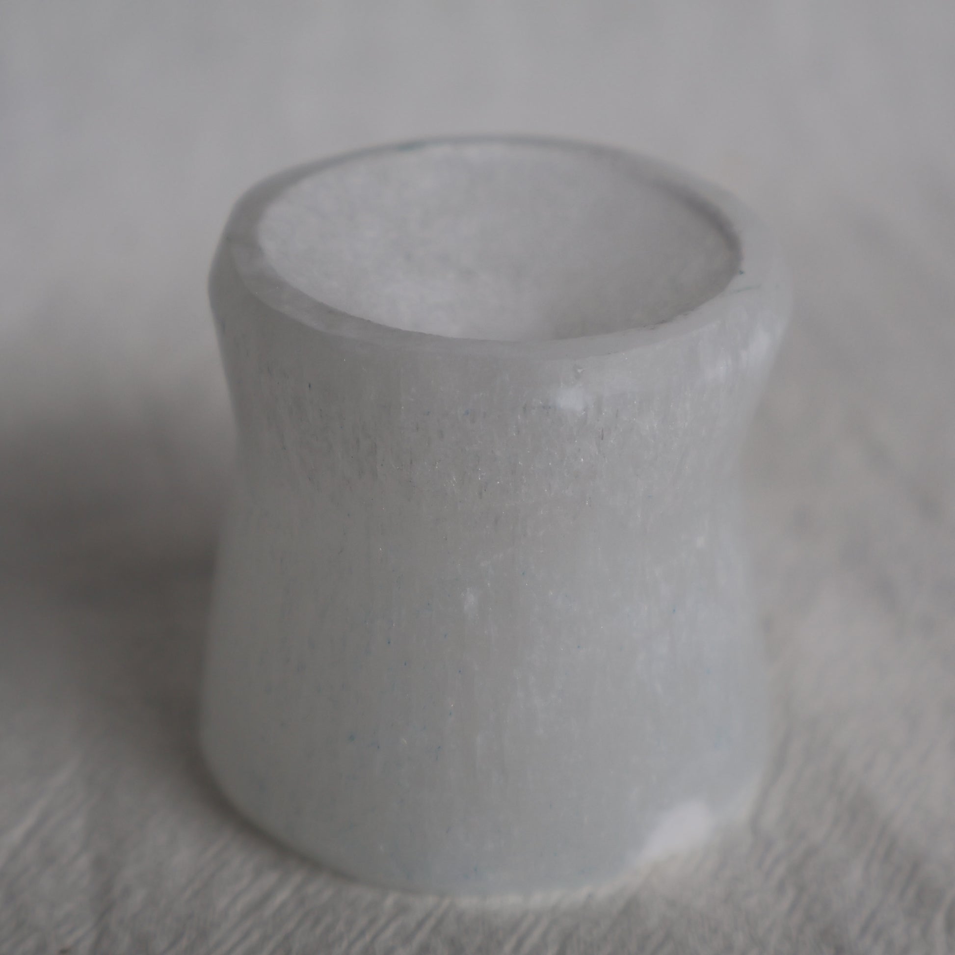 Gray stone ring on a textured surface
