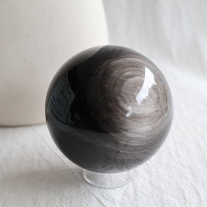 Silver Sheen Obsidian crystal spheres with deep black colouring and reflective silver-grey circular sheen, available to choose by exact piece.