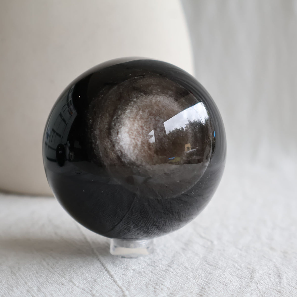 Silver Sheen Obsidian crystal spheres with deep black colouring and reflective silver-grey circular sheen, available to choose by exact piece.