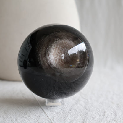 Silver Sheen Obsidian crystal spheres with deep black colouring and reflective silver-grey circular sheen, available to choose by exact piece.