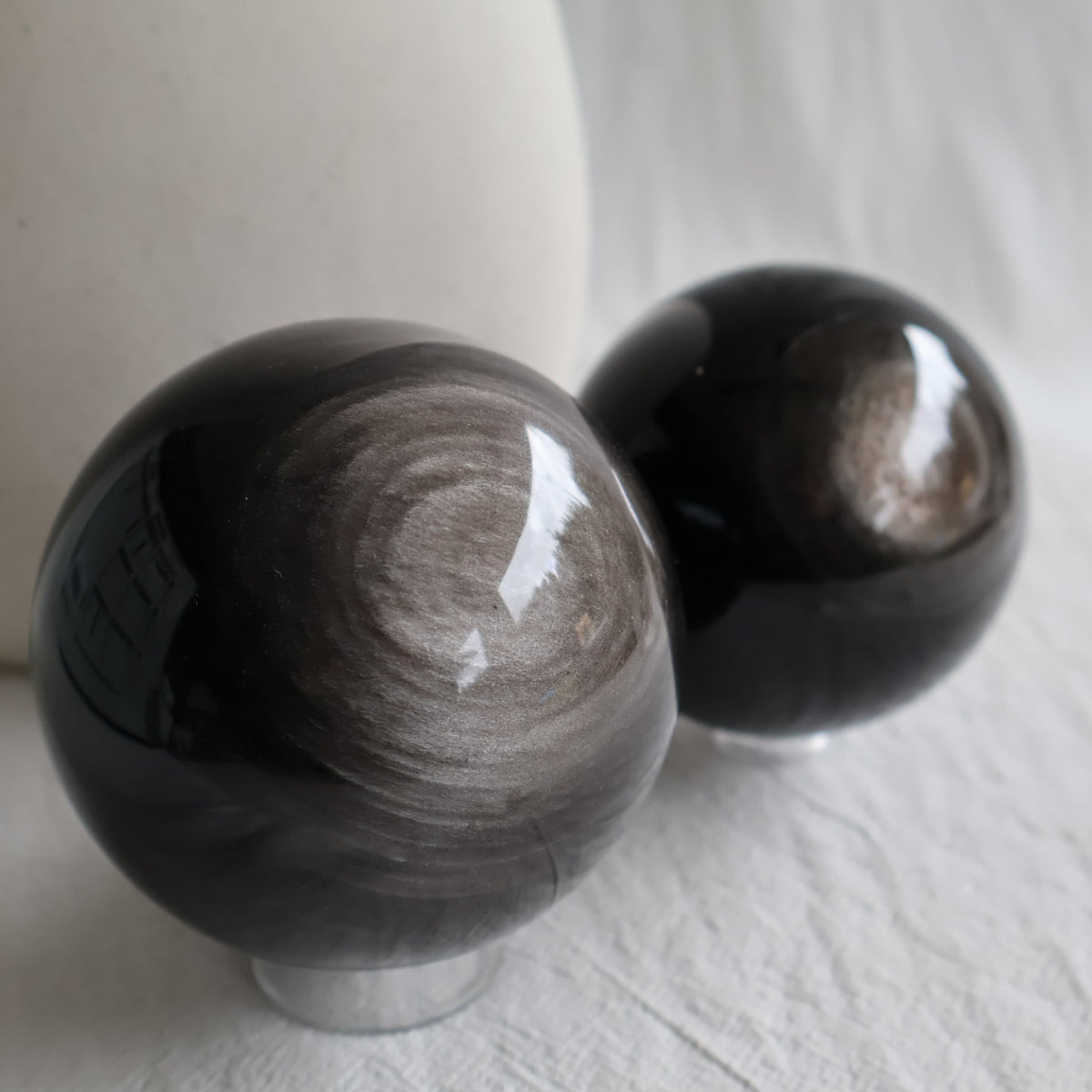 Silver Sheen Obsidian crystal spheres with deep black colouring and reflective silver-grey circular sheen, available to choose by exact piece.