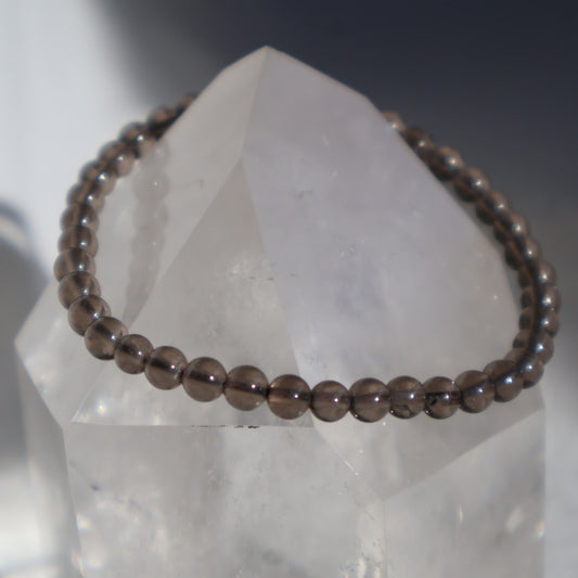 Smoky Quartz 4mm bead stretch bracelet with petite translucent beads in natural smoky brown and grey tones.