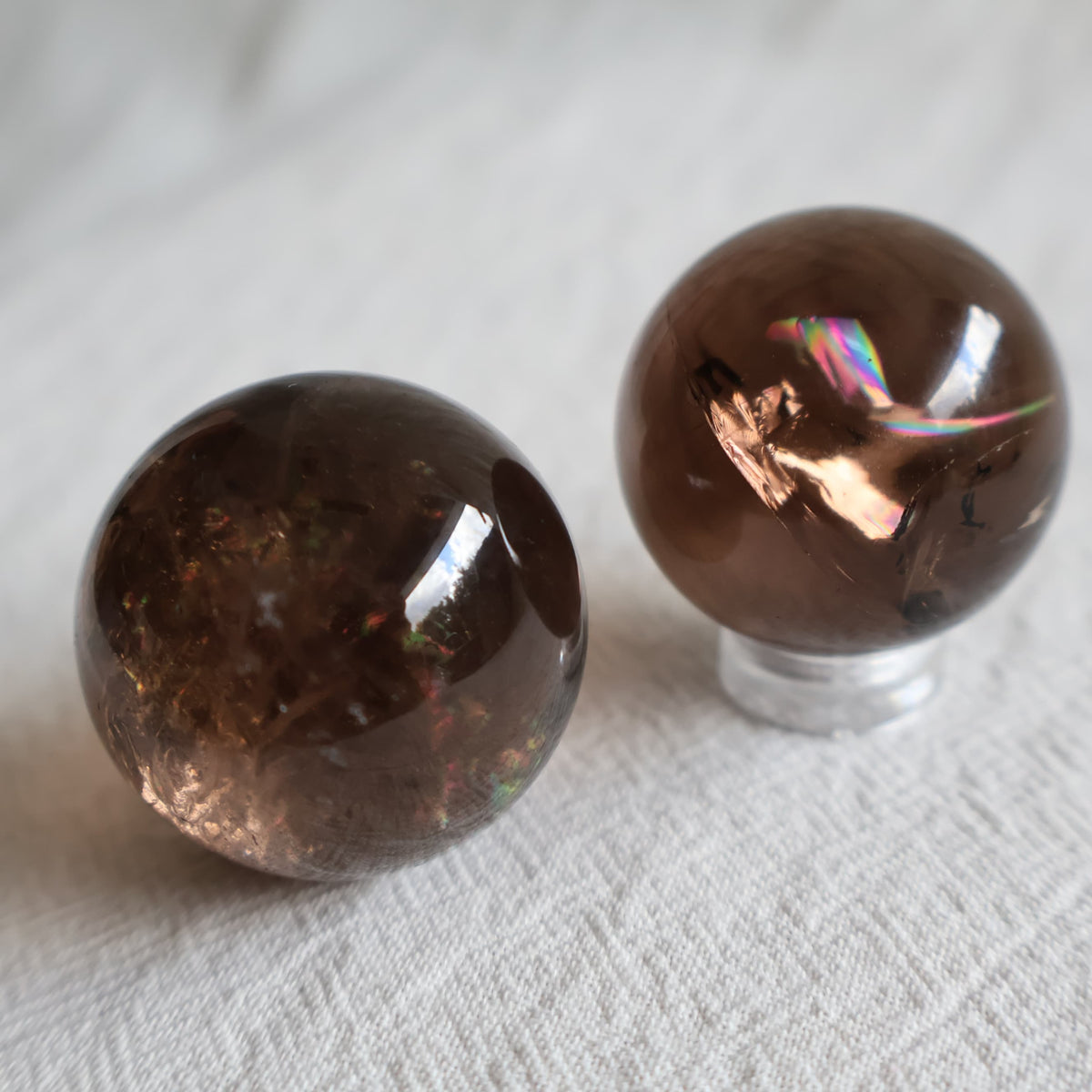 High-quality 3cm Smoky Quartz mini spheres with polished finish, natural inclusions and internal rainbow flashes.