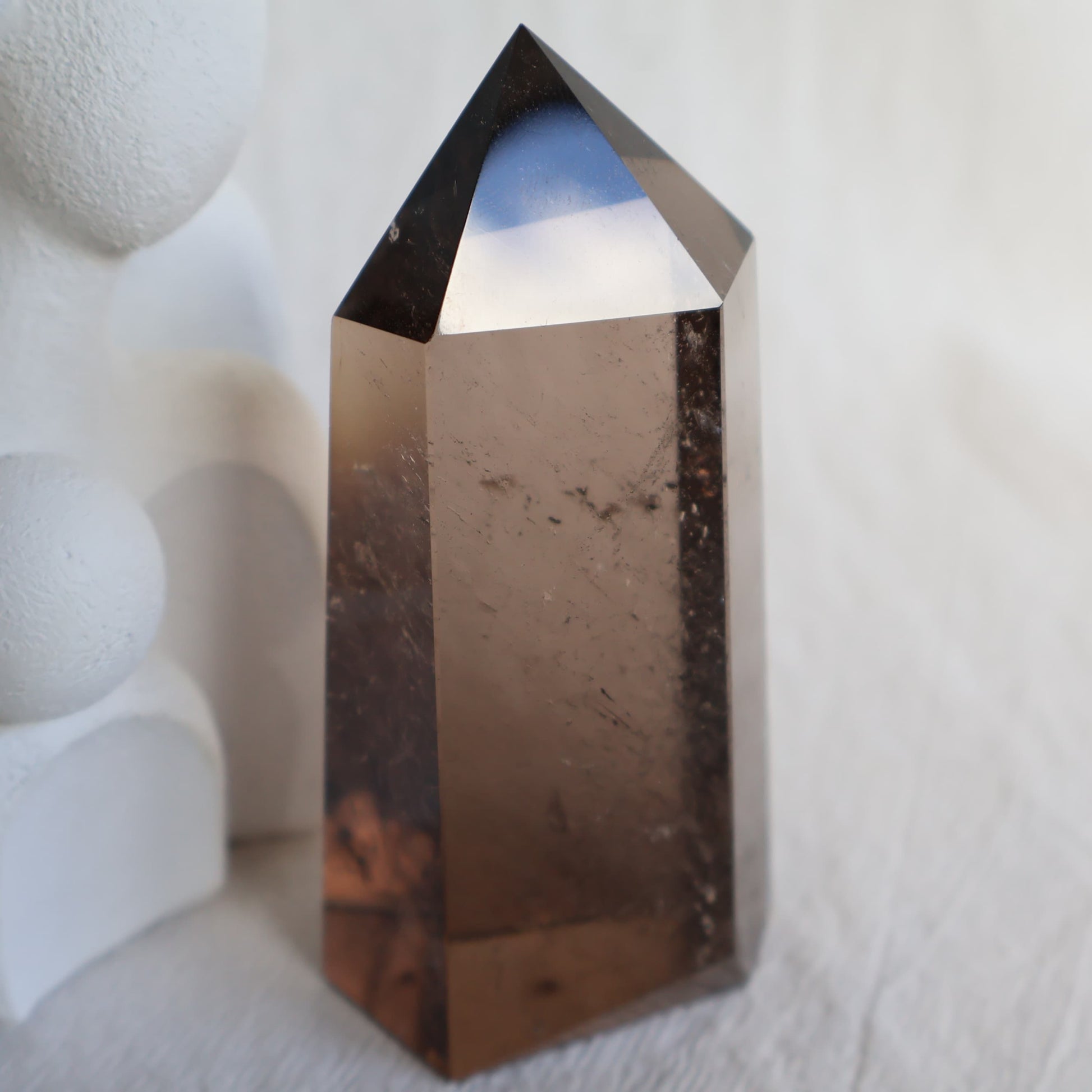 Smoky Quartz six-sided tower with natural translucent smoky brown tones, 7.5cm tall and weighing approximately 163g.