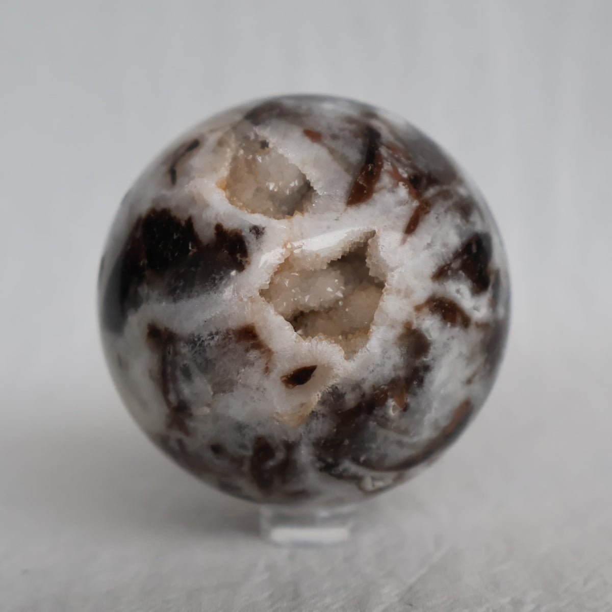 Sphalerite crystal sphere with earthy natural tones, polished patterning and sparkling druzy crystal pockets, approximately 6cm wide.