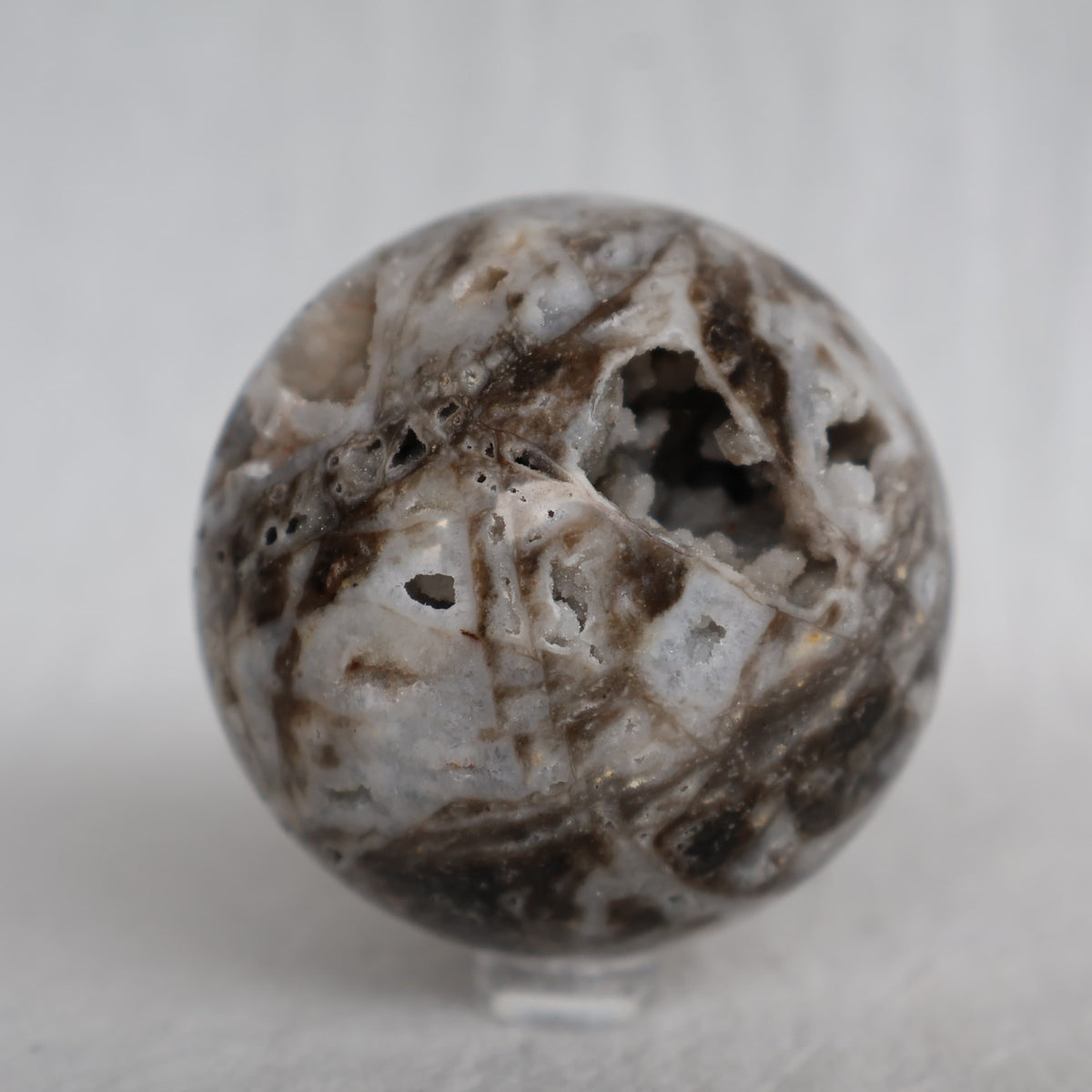 Sphalerite crystal sphere with earthy natural tones, polished patterning and sparkling druzy crystal pockets, approximately 6cm wide.