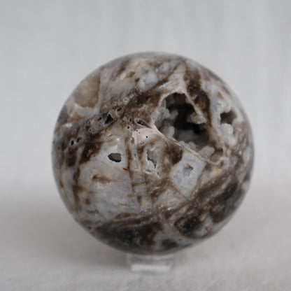 Sphalerite crystal sphere with earthy natural tones, polished patterning and sparkling druzy crystal pockets, approximately 6cm wide.