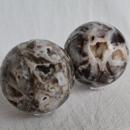 Sphalerite crystal sphere with earthy natural tones, polished patterning and sparkling druzy crystal pockets, approximately 6cm wide.