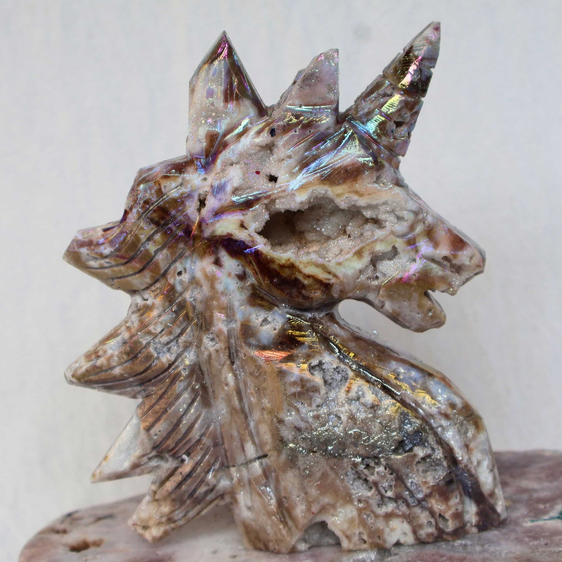 Aura coated sphalerite unicorn carving iridescent crystal – Stonewild
