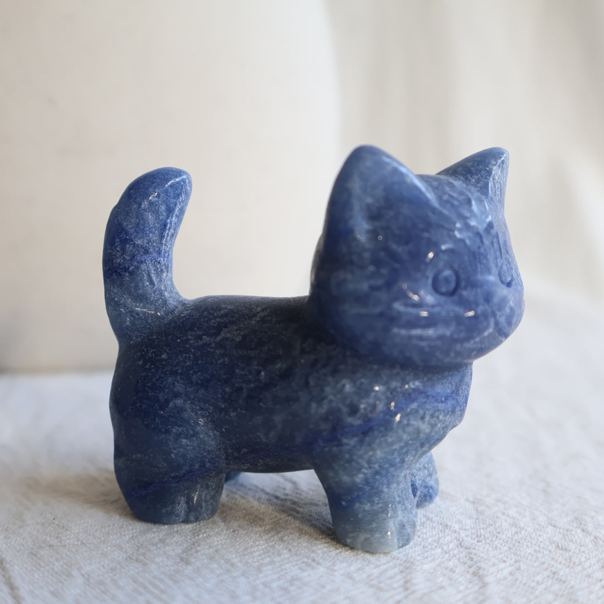 Medium standing cat crystal carvings in Rose Quartz, Fire Quartz, Blue Aventurine and Larvikite, approximately 5cm tall.