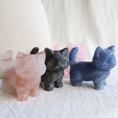 Medium standing cat crystal carvings in Rose Quartz, Fire Quartz, Blue Aventurine and Larvikite, approximately 5cm tall.