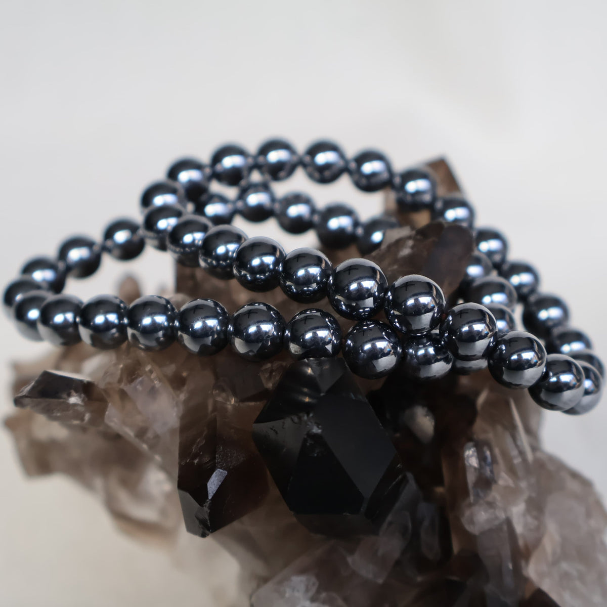 Terahertz Stone 8mm stretch bracelet with smooth metallic-grey beads and a highly reflective finish.